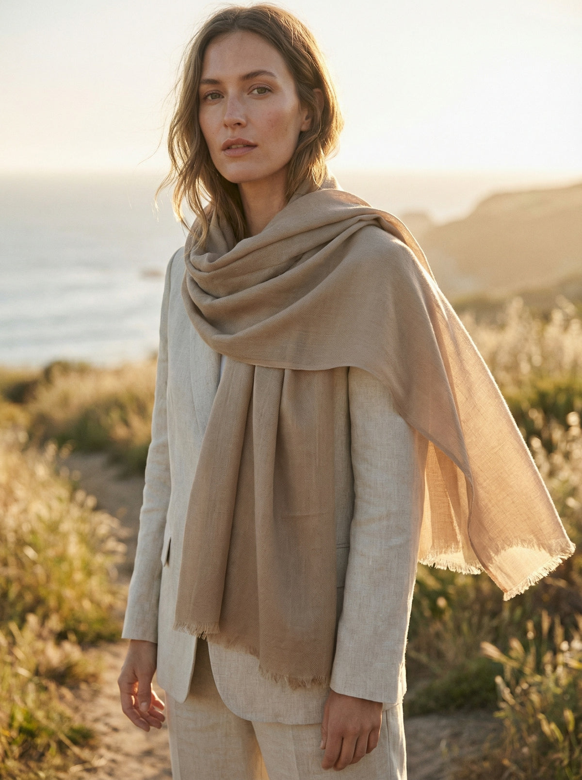 Khaki Tagelmust styled as a lightweight travel scarf for women, Touareg inspired Moroccan shawl for desert sun protection.