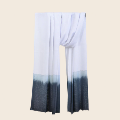 Ghost White Soaked Tagelmust scarf – crisp white hanging wrap fading through ice‑blue to charcoal grey gradient. Sustainably sourced lightweight Moroccan headscarf ideal for nomadic travelers searching for white, blue, or grey scarves for hot‑weather, dry‑climate adventures.